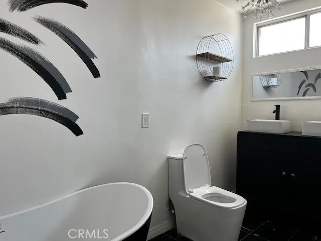 a white toilet sitting next to a bathroom sink