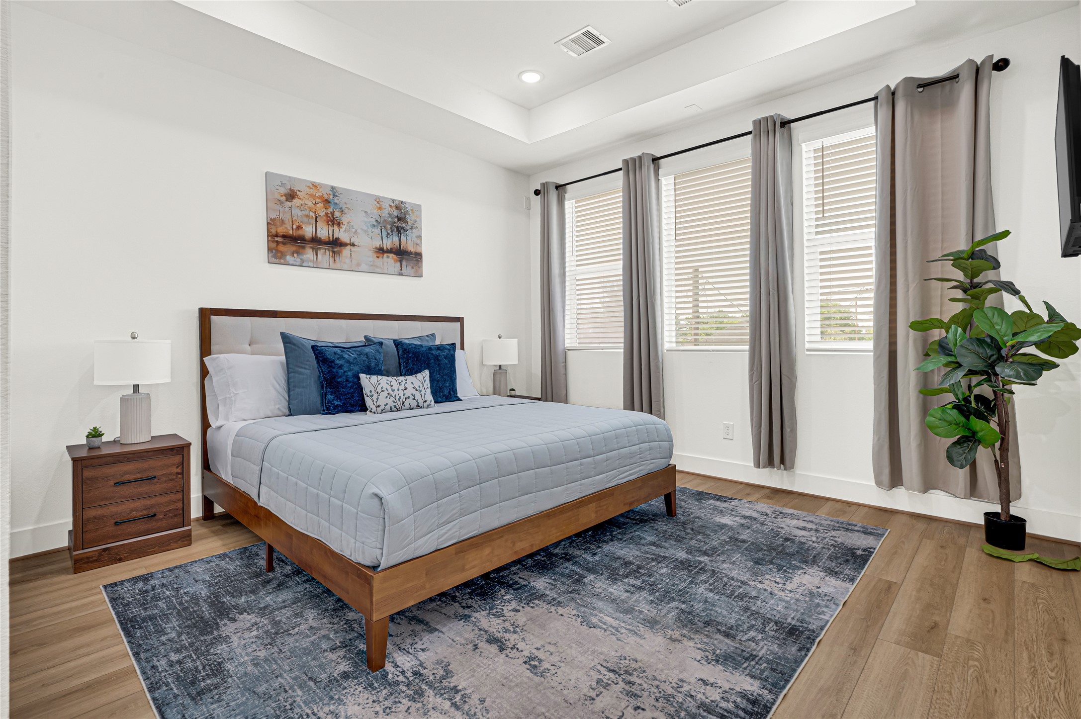 4201 Stassen Street Houston, TX 77051 - Photo 18 of 39 a bedroom with a large bed and a potted plant