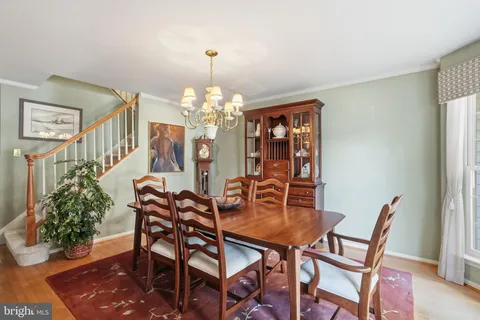 a dining room with furniture and chandelier