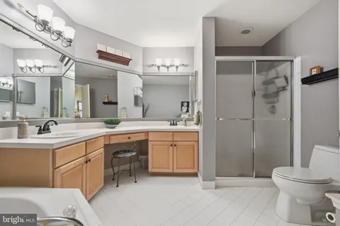 a spacious bathroom with a shower sink and mirror