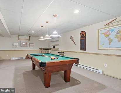 a room with furniture and pool table