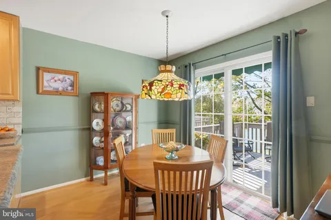 a dining room with furniture a chandelier and wooden floor