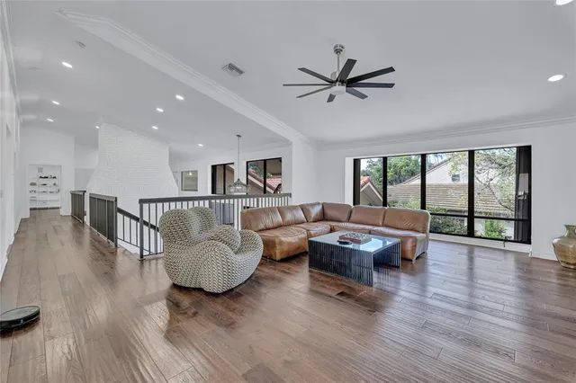 a view of a livingroom with furniture window and wooden floor