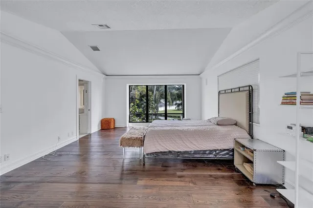 a bedroom with a large bed and a large window