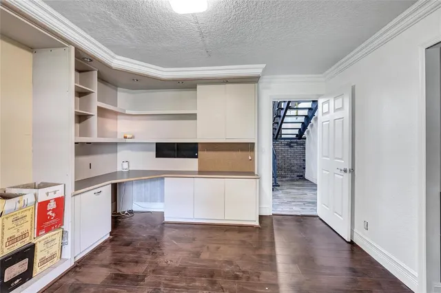 an empty room with a window and cabinet