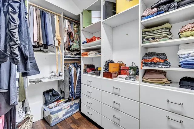 an aerial view of residential houses with outdoor space and trees