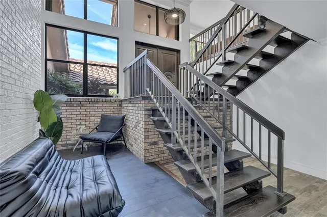 an aerial view of residential houses with outdoor space and trees