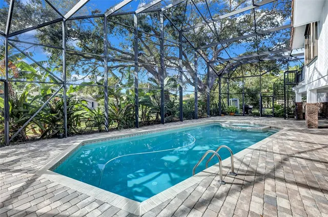 a view of a street with potted plants and large trees