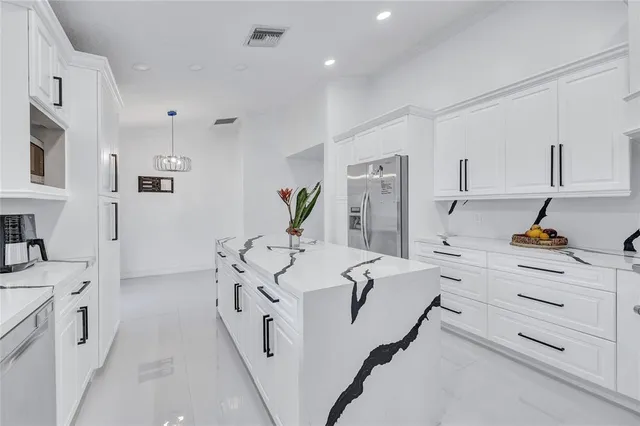 a kitchen with white cabinets and white appliances