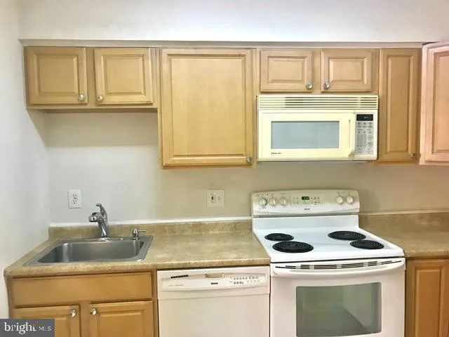 a utility room with a sink washer and dryer
