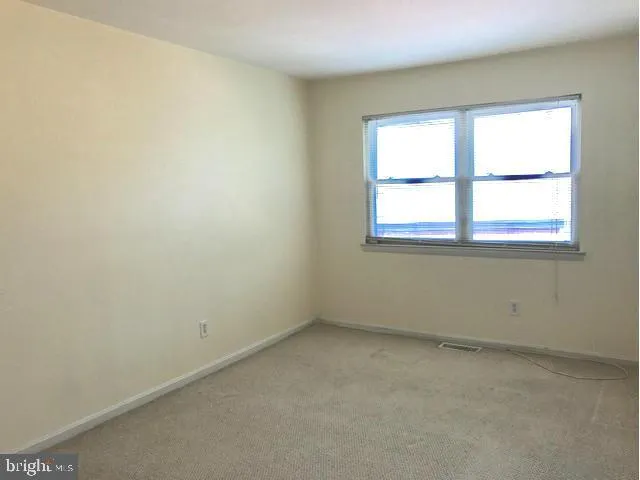 an empty room with closet area