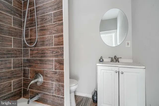 a bathroom with a shower and a sink