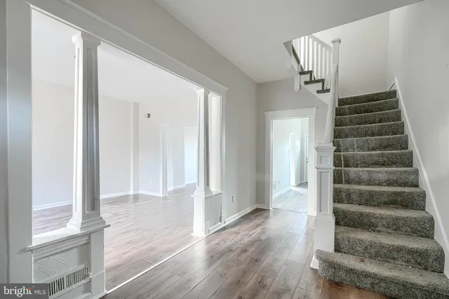 a view of an entryway with wooden floor and door