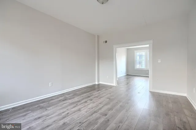 a view of wooden floor and windows in a room