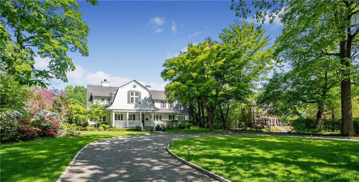 Beautifully renovated Colonial is setback from the road with a circular driveway  - wonderful curb appeal and easy access for family and friends.