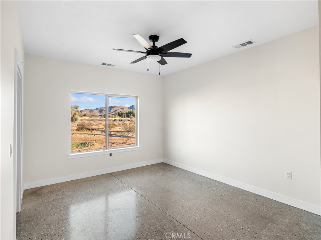 16173 Pela Road Apple Valley, CA 92307 - Photo 18 of 36 an empty room with windows and fan