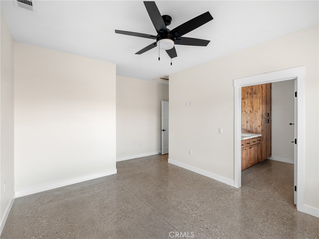 16173 Pela Road Apple Valley, CA 92307 - Photo 19 of 36 an empty room with chandelier fan