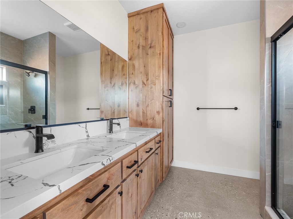 16173 Pela Road Apple Valley, CA 92307 - Photo 20 of 36 a bathroom with a granite countertop sink a mirror and shower
