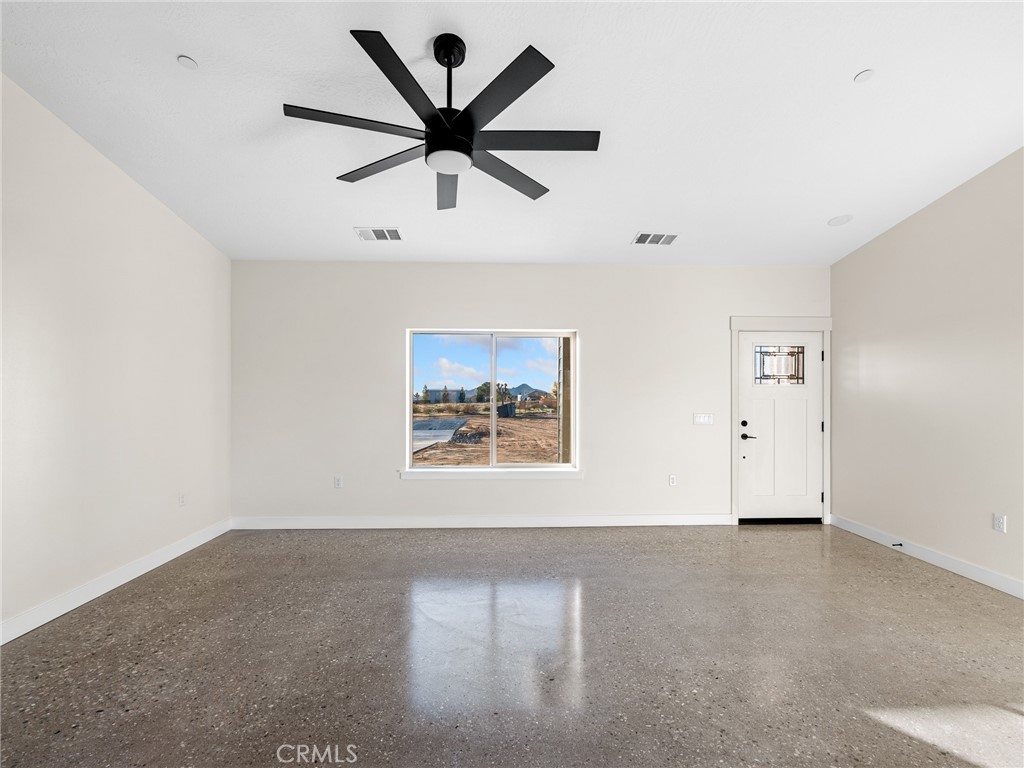 16173 Pela Road Apple Valley, CA 92307 - Photo 2 of 36 an empty room with window and ceiling fan