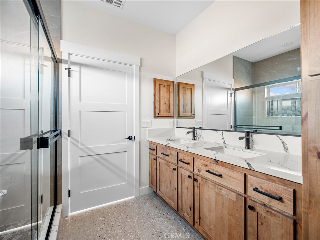 16173 Pela Road Apple Valley, CA 92307 - Photo 21 of 36 a spacious bathroom with a granite countertop sink mirror and double