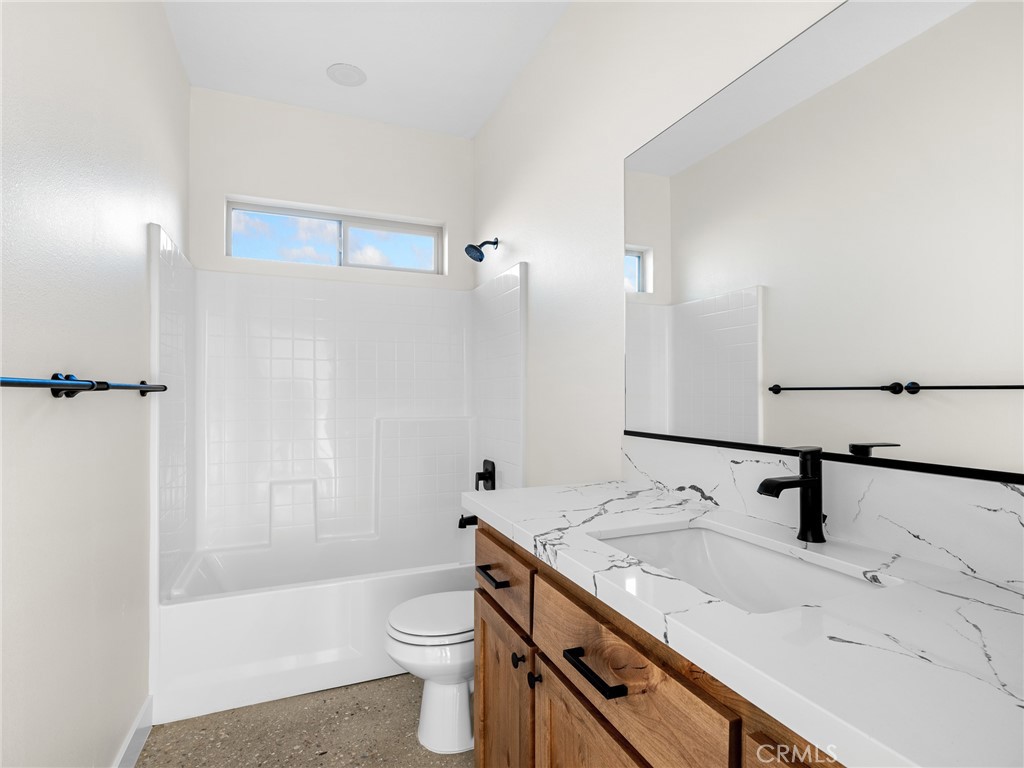 16173 Pela Road Apple Valley, CA 92307 - Photo 10 of 36 a bathroom with a sink a toilet and shower