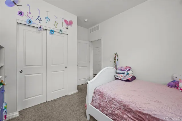 a bedroom with a bed and cabinets