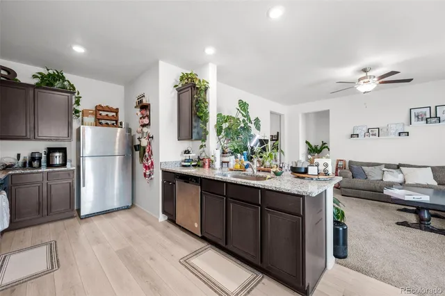 a kitchen with refrigerator and cabinets