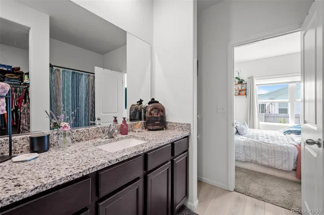 a bathroom with a granite countertop sink and a mirror