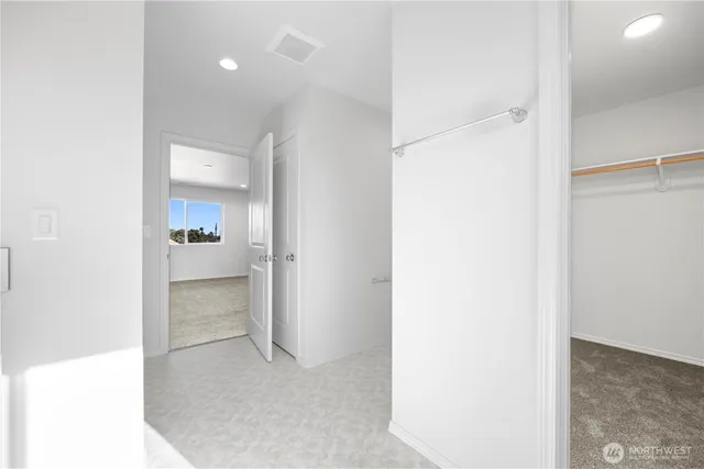 a view of a hallway with kitchen and a sink