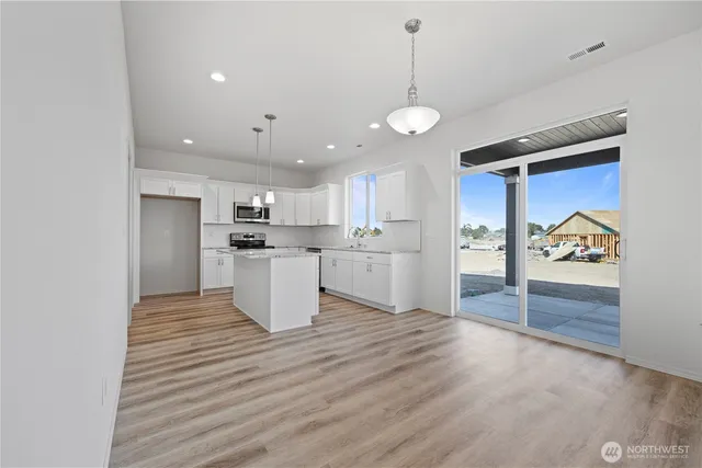 a kitchen with stainless steel appliances kitchen island wooden cabinets and granite counter tops