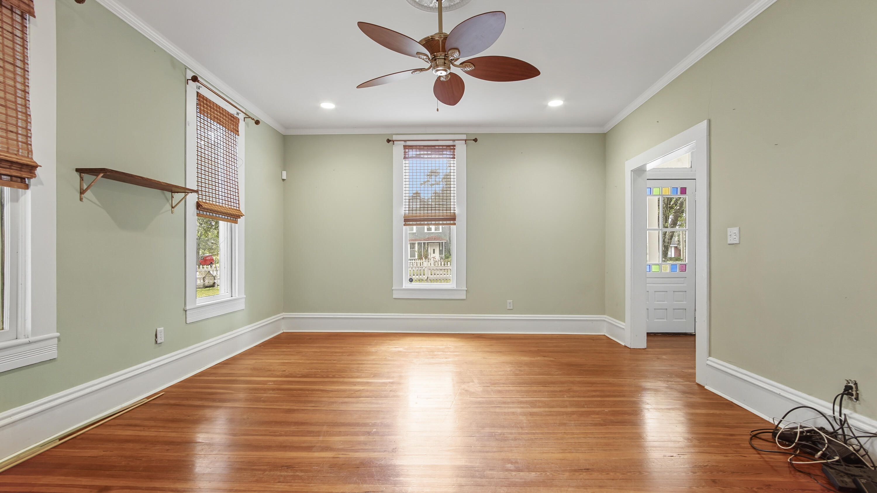 87 Bay Avenue DeFuniak Springs, FL 32435 - Photo 12 of 55 a view of an empty room with window and wooden floor