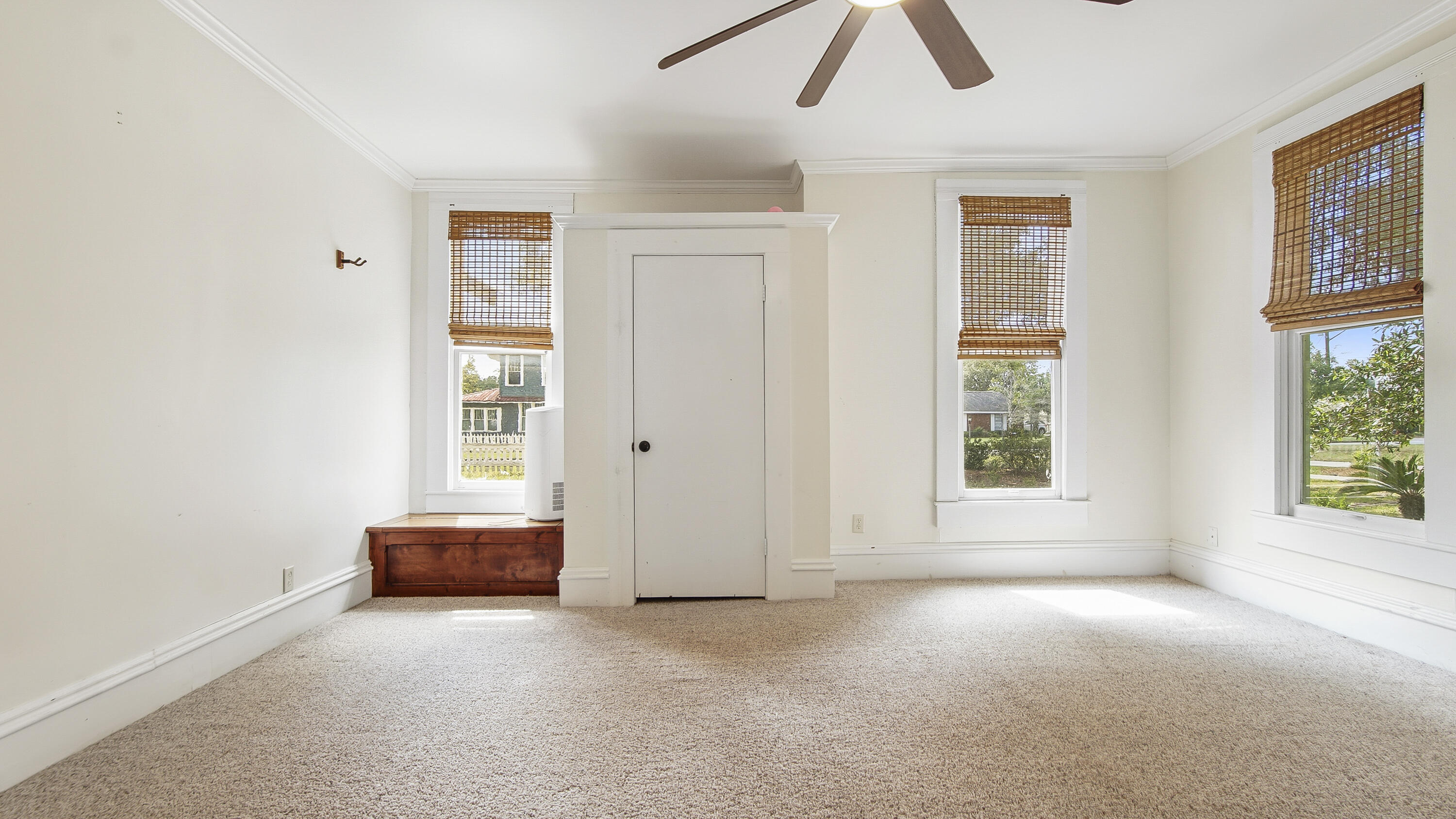 87 Bay Avenue DeFuniak Springs, FL 32435 - Photo 14 of 55 an empty room with chandelier fan and windows