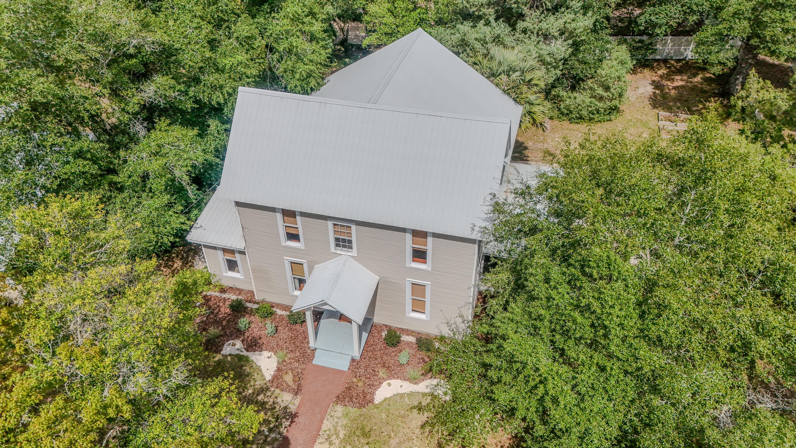 87 Bay Avenue DeFuniak Springs, FL 32435 - Photo 2 of 55 an aerial view of a house with yard and trees in the background