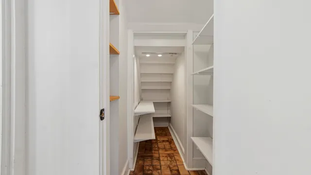 a view of hallway with toilet