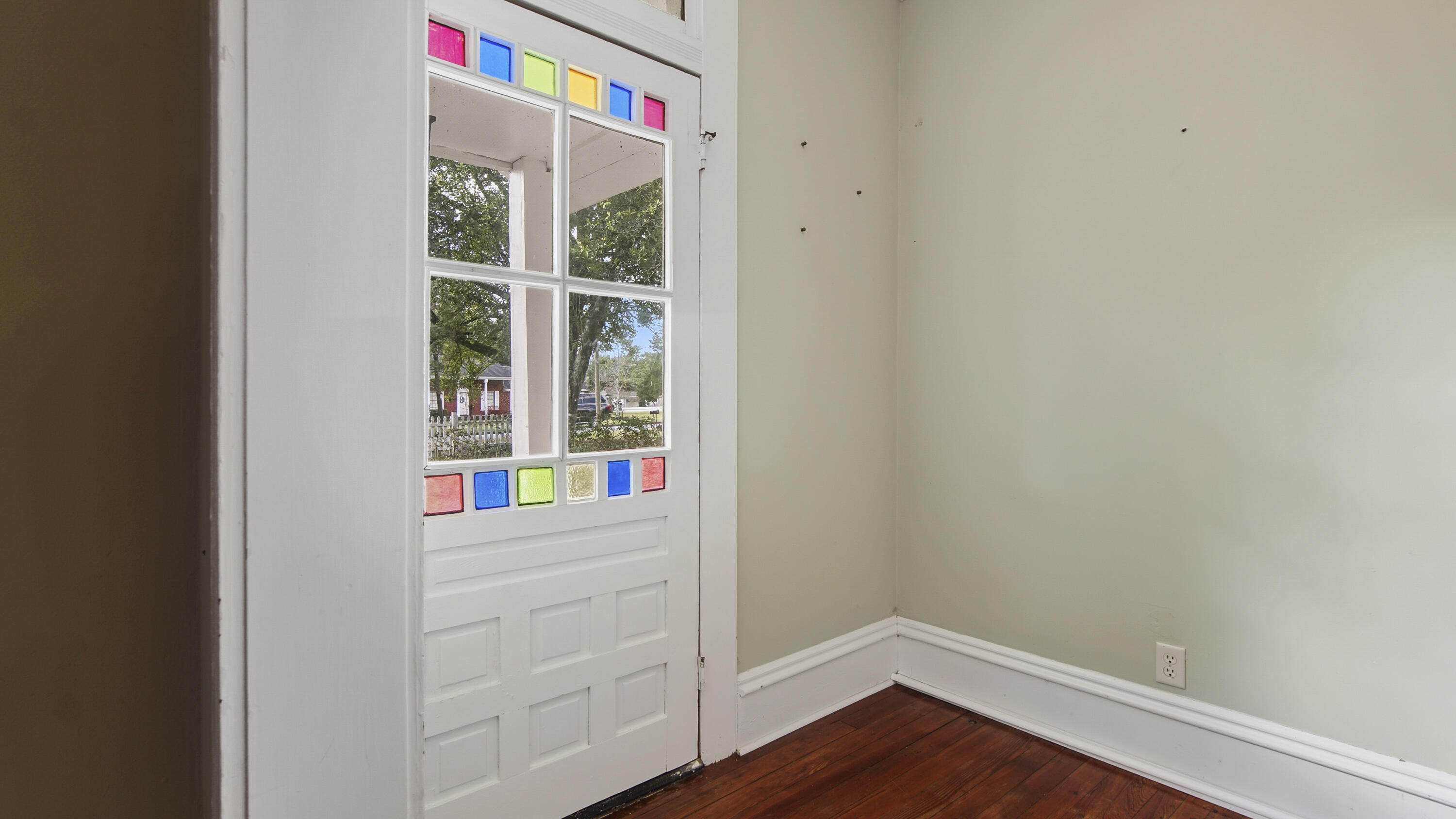 87 Bay Avenue DeFuniak Springs, FL 32435 - Photo 22 of 55 a view of an empty room with wooden floor and windows