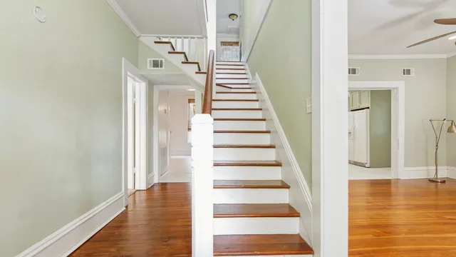 a view of entryway and hall with wooden floor