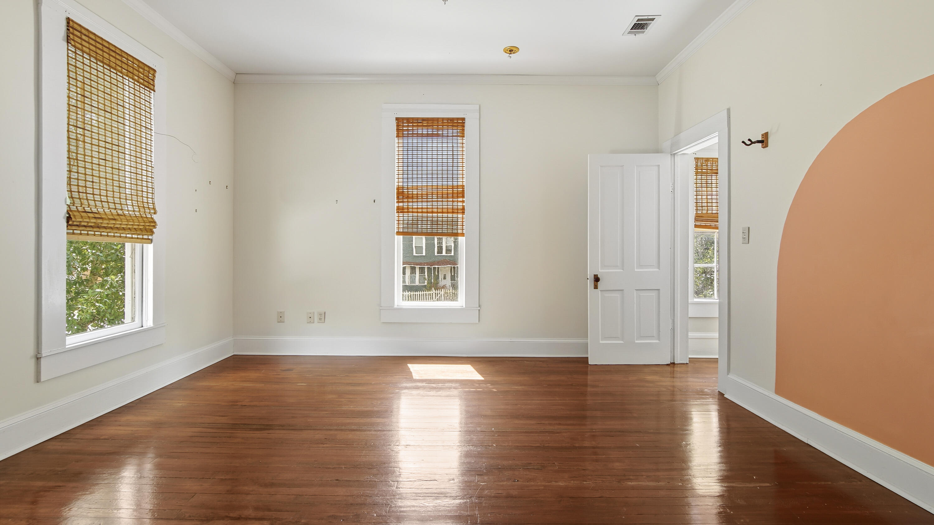 87 Bay Avenue DeFuniak Springs, FL 32435 - Photo 31 of 55 an empty room with wooden floor and windows