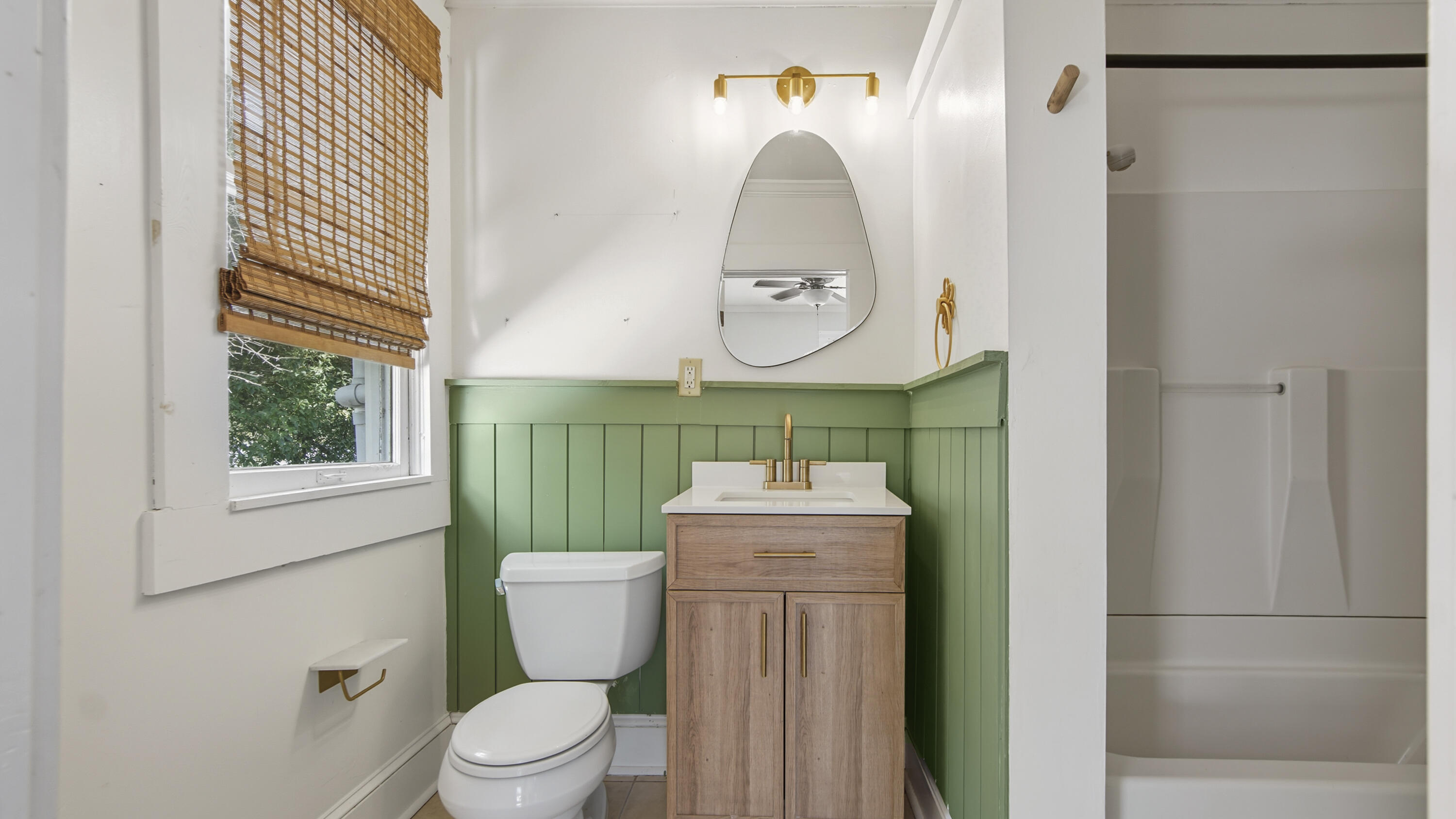 87 Bay Avenue DeFuniak Springs, FL 32435 - Photo 32 of 55 a bathroom with a toilet sink vanity and mirror