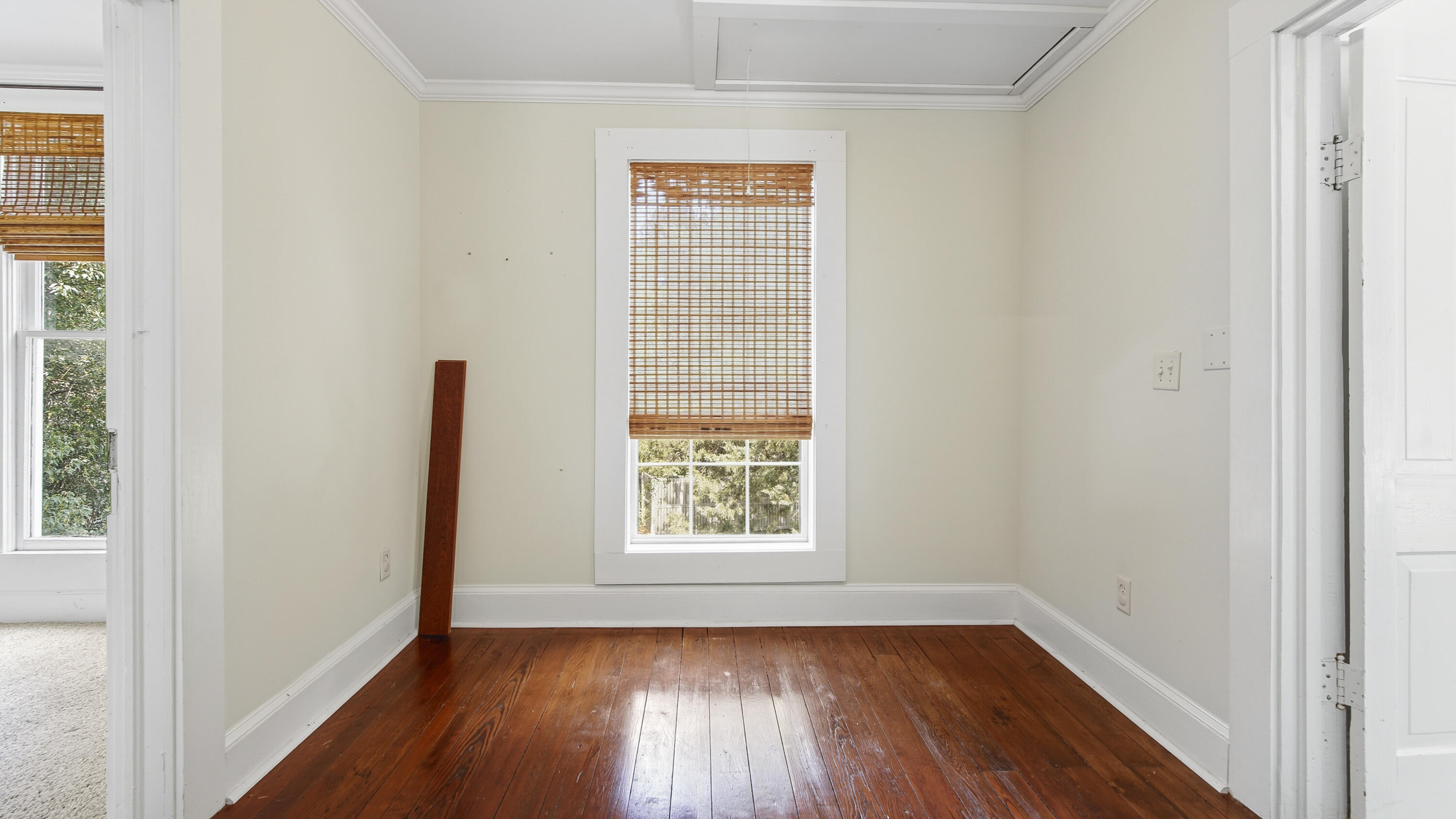 87 Bay Avenue DeFuniak Springs, FL 32435 - Photo 34 of 55 a view of an empty room with wooden floor and a window