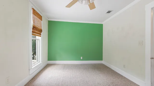 an empty room with closet and windows