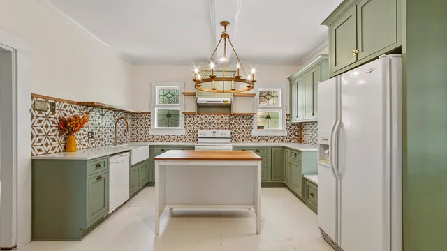 a kitchen with stainless steel appliances a stove and refrigerator
