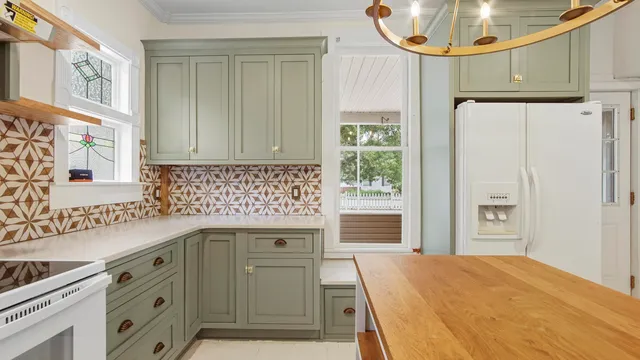 a kitchen with stainless steel appliances a stove a sink and a refrigerator
