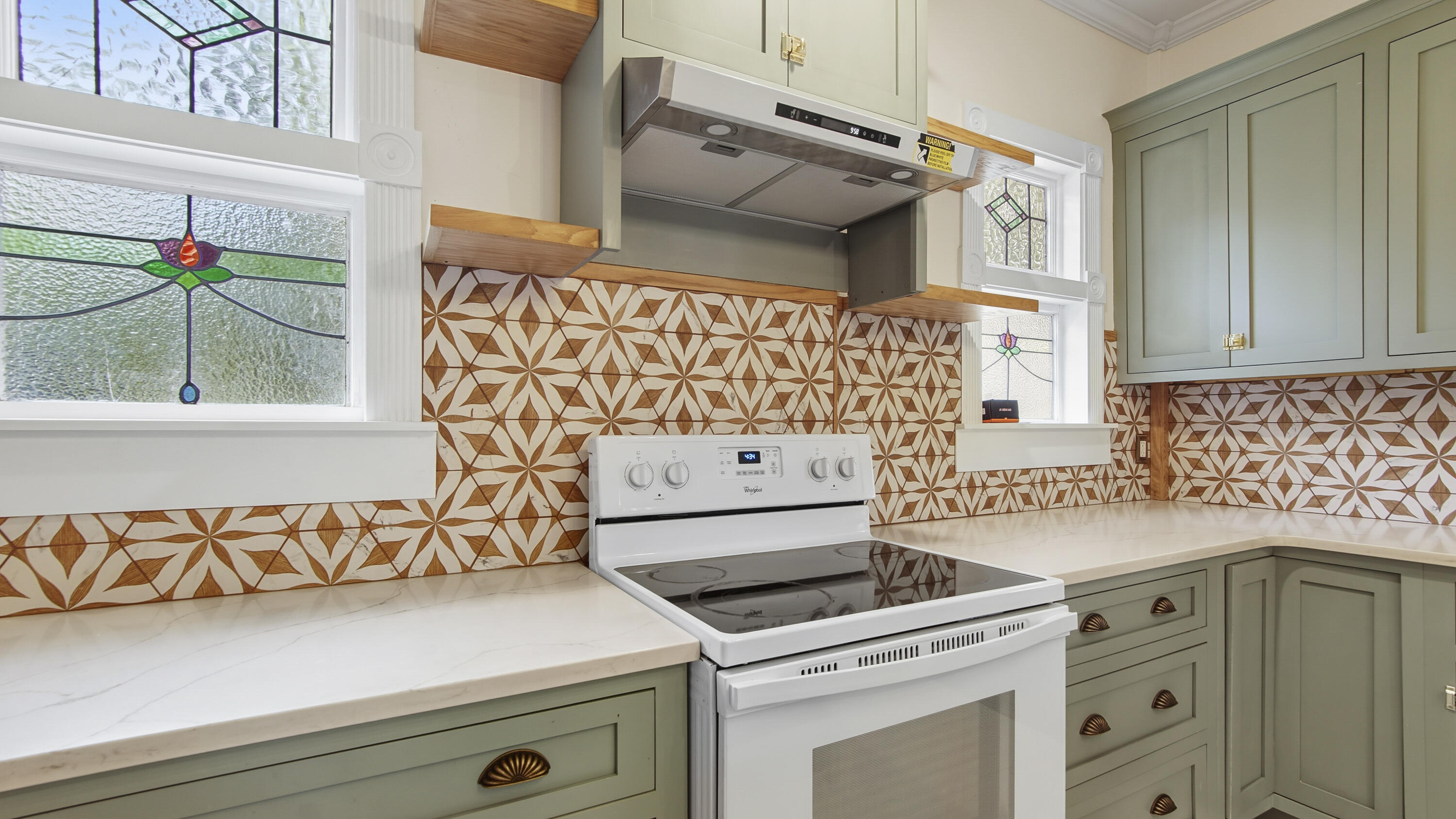 87 Bay Avenue DeFuniak Springs, FL 32435 - Photo 9 of 55 a kitchen with a stove and a cabinets