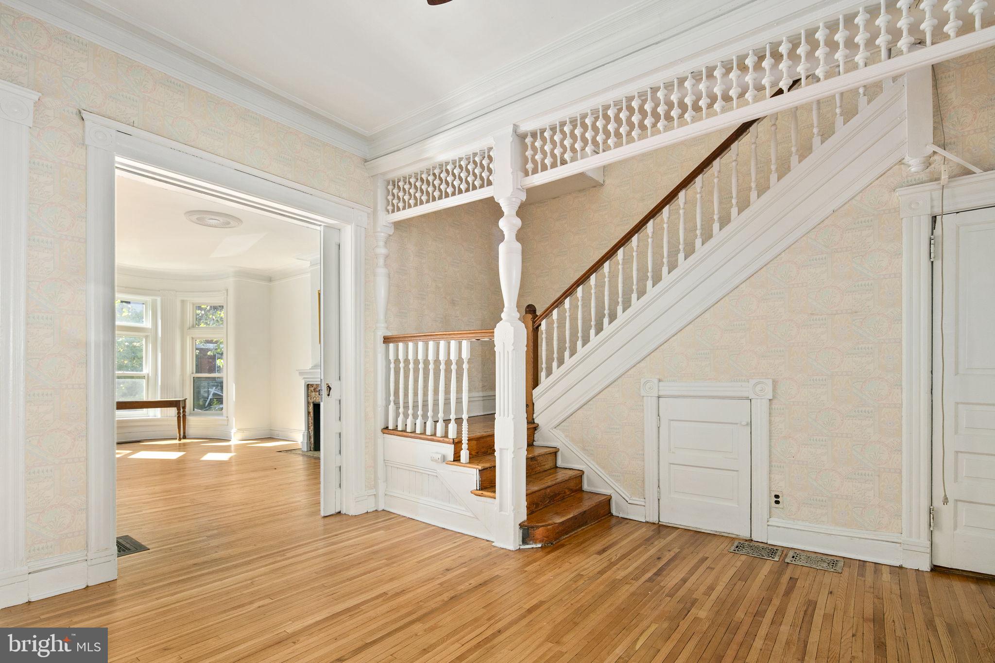 a view of entryway with wooden floor and stairs