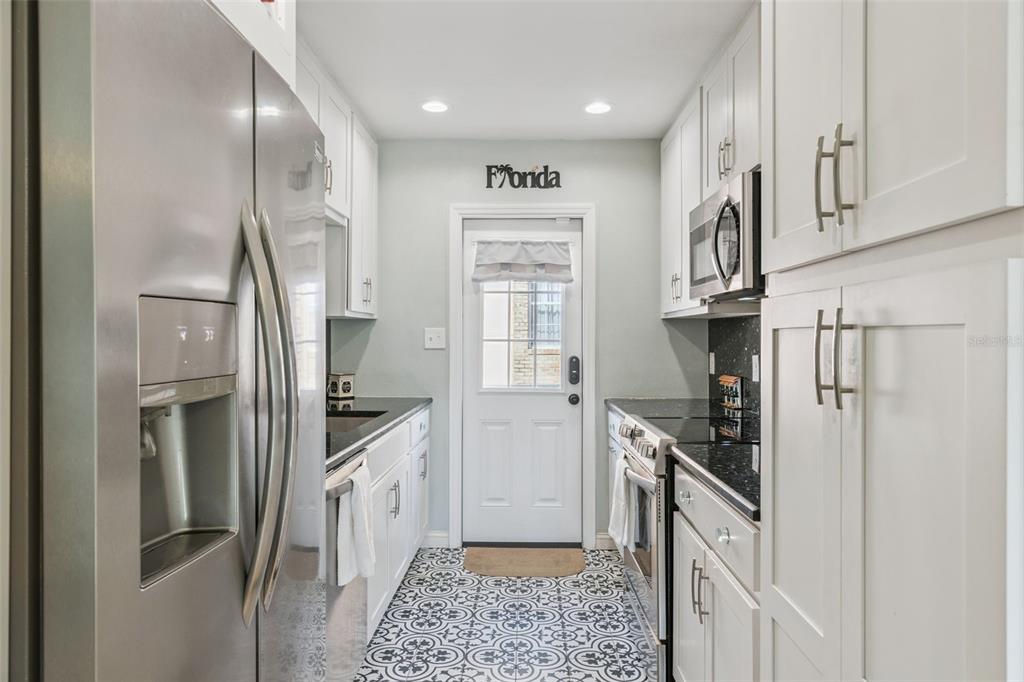 124 East Harding Street Orlando, FL 32806 - Photo 11 of 21 a kitchen with stainless steel appliances granite countertop a refrigerator and a sink