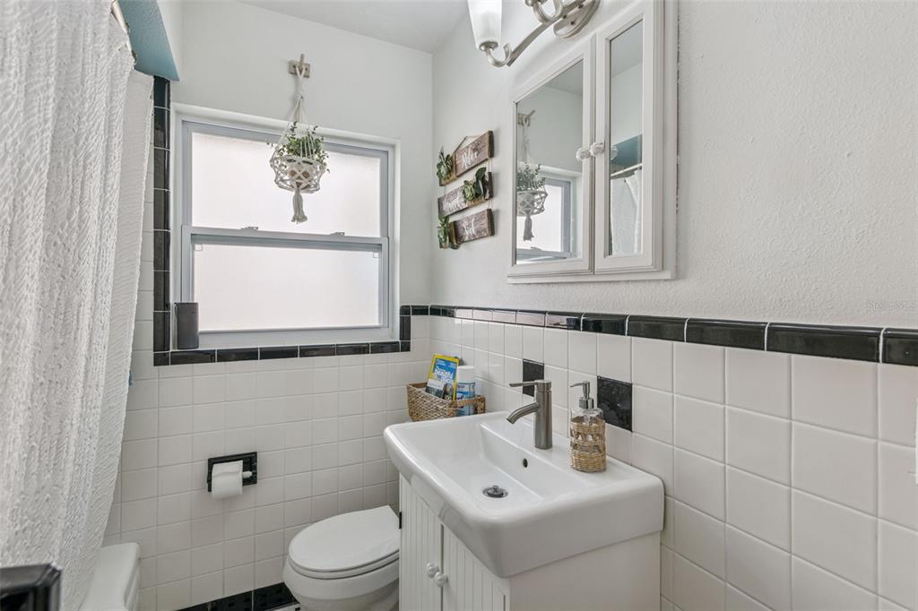 124 East Harding Street Orlando, FL 32806 - Photo 16 of 21 a bathroom with a sink a toilet and mirror