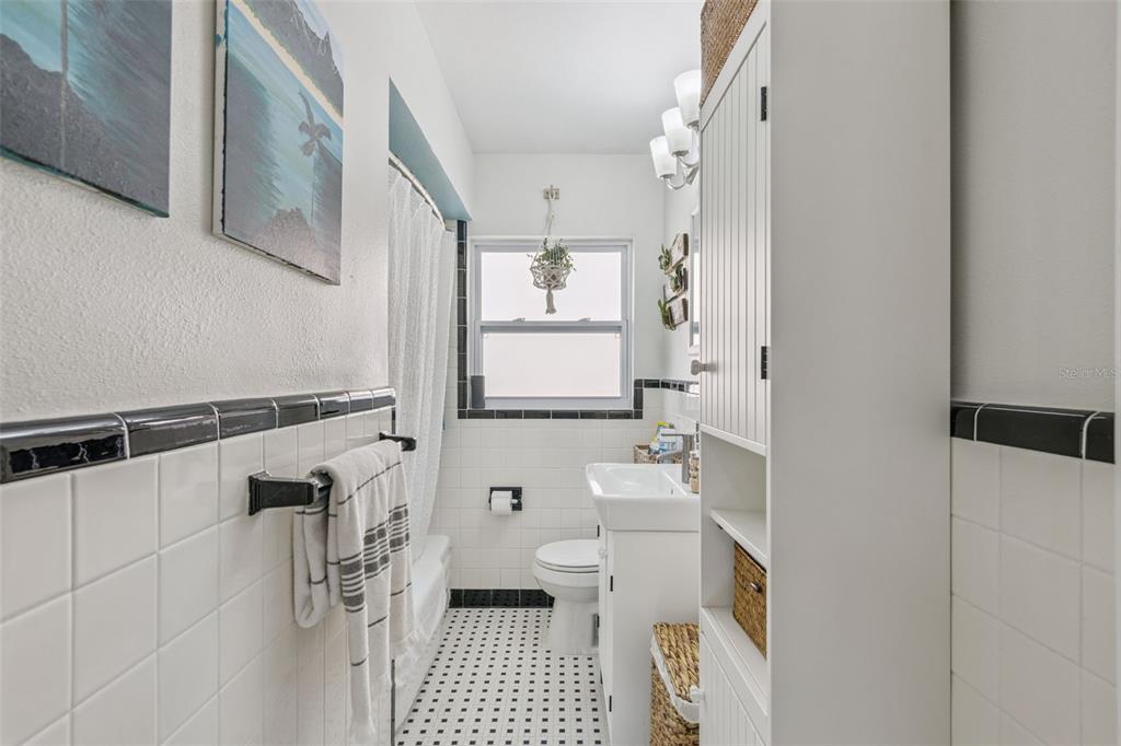 124 East Harding Street Orlando, FL 32806 - Photo 17 of 21 a bathroom with a sink a toilet and a shower curtain