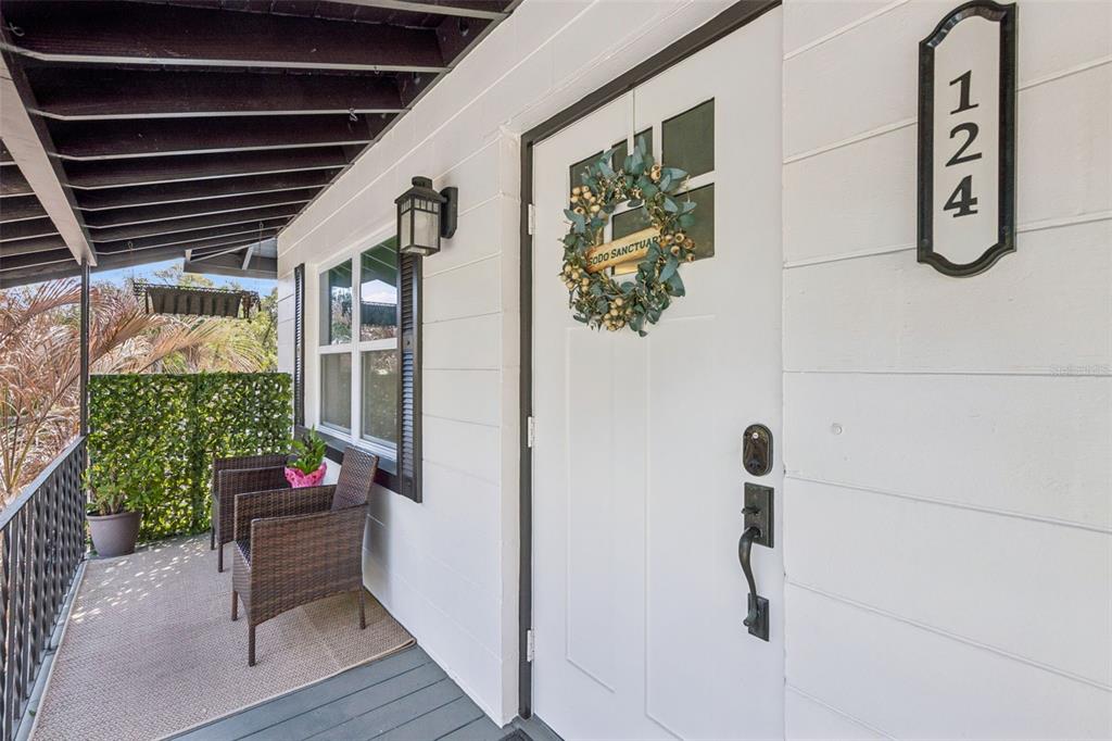124 East Harding Street Orlando, FL 32806 - Photo 4 of 21 a hallway with flowers and wooden floor