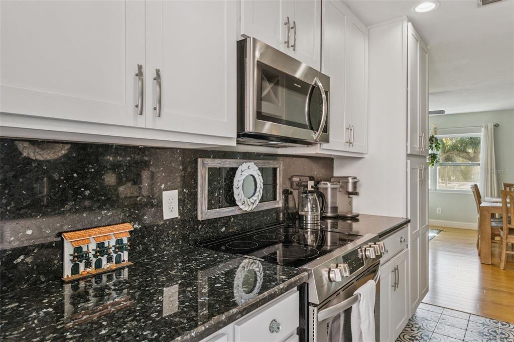 124 East Harding Street Orlando, FL 32806 - Photo 9 of 21 a kitchen with stainless steel appliances granite countertop a stove and a microwave