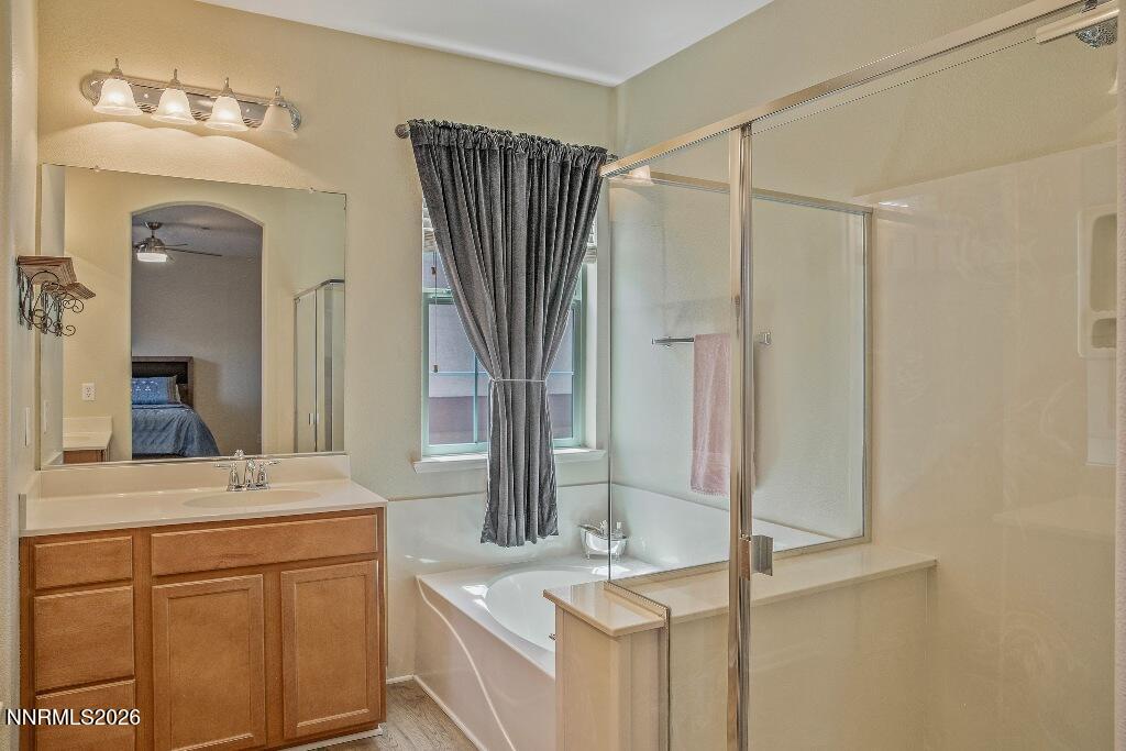 1864 Wind Ranch Road, Unit B Reno, NV 89521 - Photo 21 of 42 a bathroom with a sink vanity granite tub and shower
